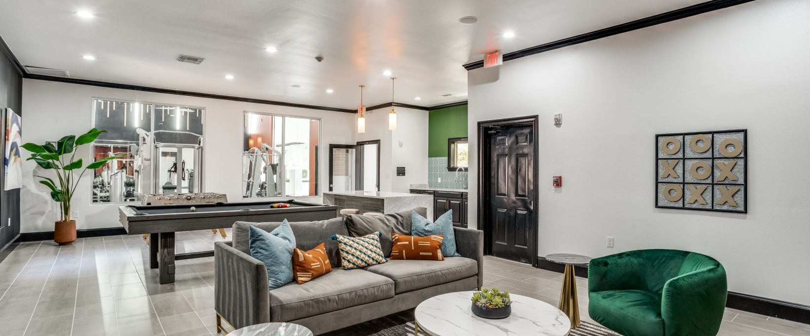 the living room has a green couch and a green table at The  Lana