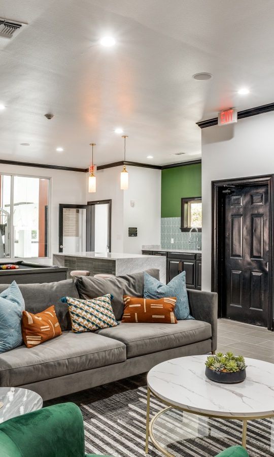 the living room has a green couch and a green table at The  Lana