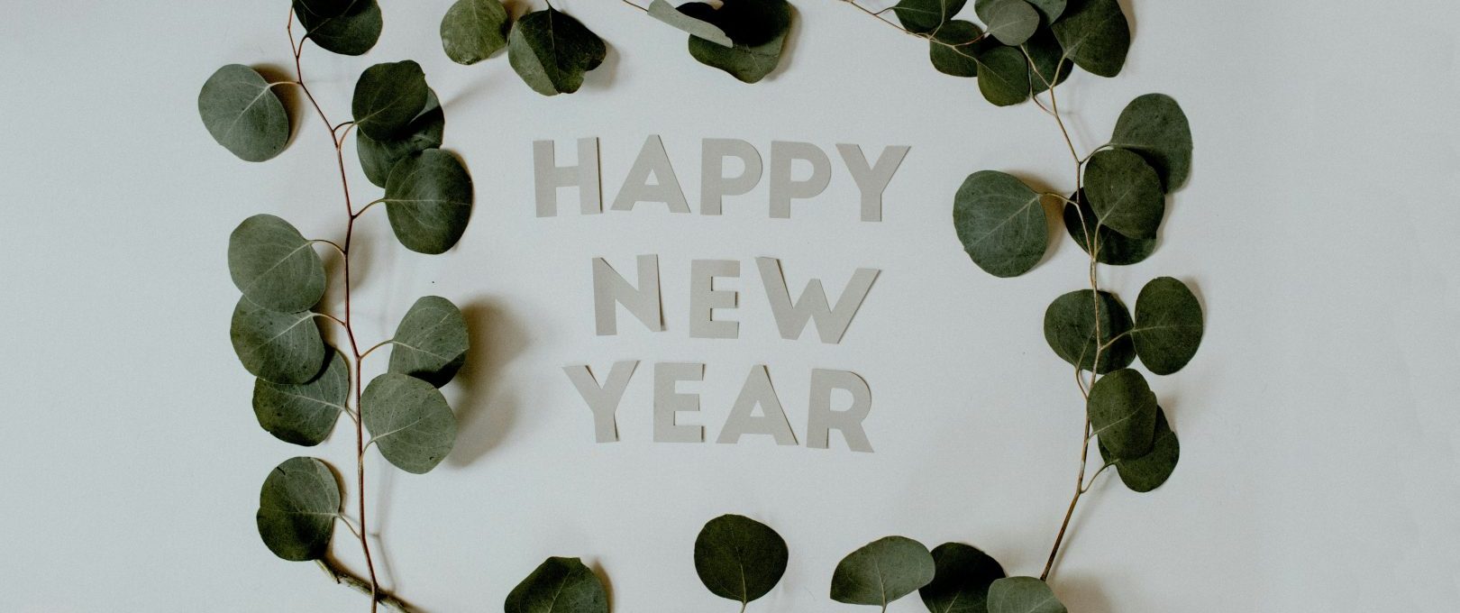 happy new year greeting card with eucalyptus leaves at The  Lana